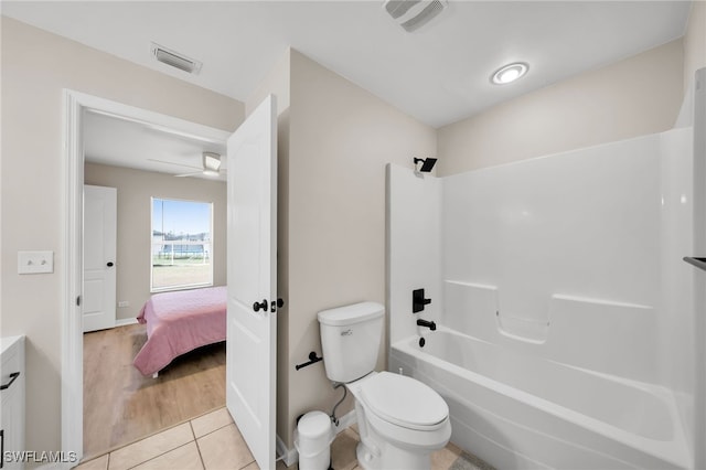 full bathroom featuring wood-type flooring, vanity, bathtub / shower combination, toilet, and ceiling fan