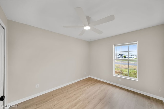 unfurnished room with ceiling fan and light wood-type flooring