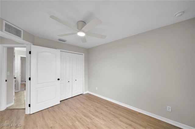 unfurnished bedroom featuring light hardwood / wood-style floors, ceiling fan, and a closet