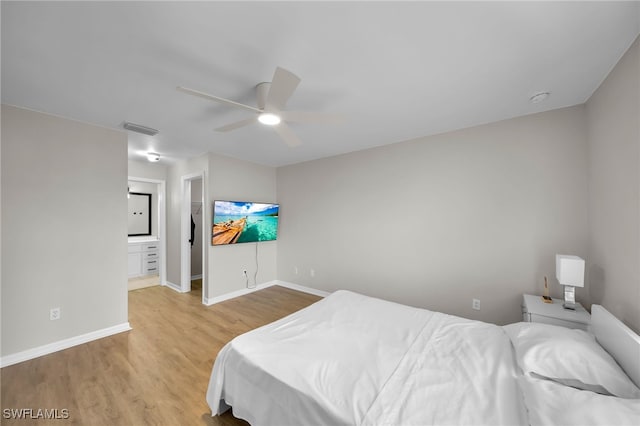 bedroom featuring ensuite bathroom, ceiling fan, and light hardwood / wood-style flooring