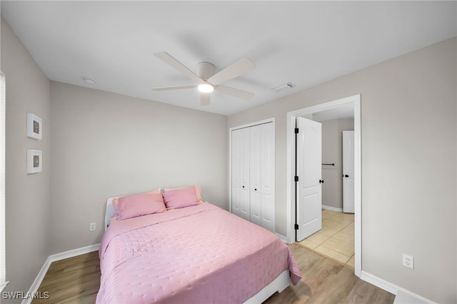 bedroom with ceiling fan, a closet, and light hardwood / wood-style flooring