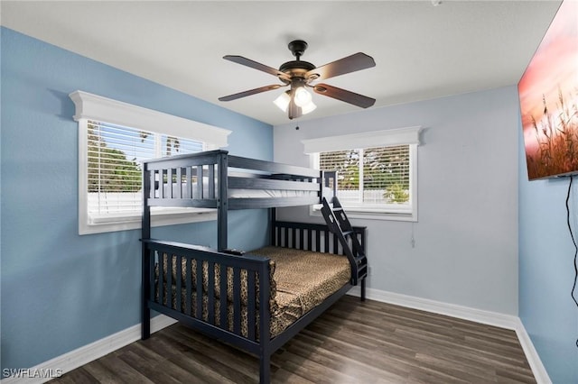 bedroom featuring ceiling fan and dark wood-type flooring