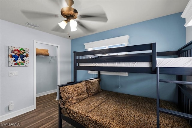 bedroom with a closet, ceiling fan, and dark hardwood / wood-style floors