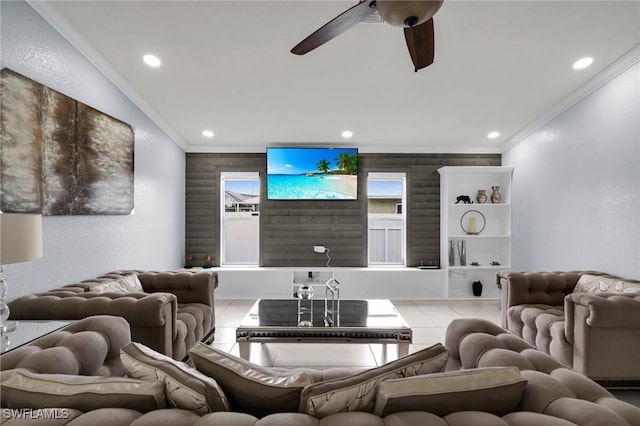 living room with ceiling fan, light tile patterned floors, and crown molding