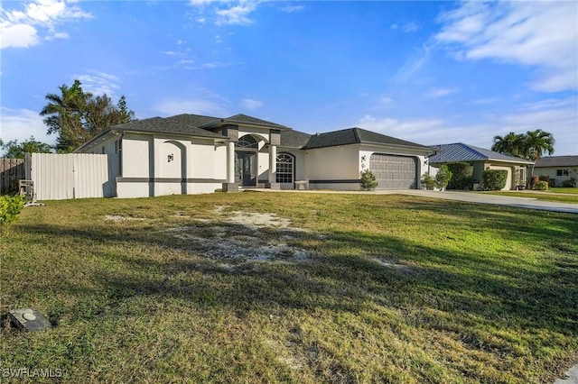 view of front of home with a garage and a front lawn