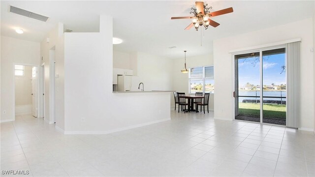 2876 Orange Grove Trl, Naples, FL 34120 - unfurnished room featuring healthy amount of natural light, a ceiling fan, baseboards, and light tile patterned flooring