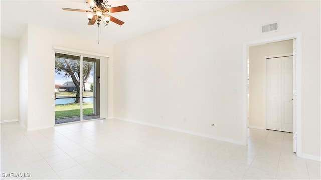 tiled empty room featuring ceiling fan