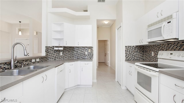 kitchen featuring white cabinets, pendant lighting, and white appliances