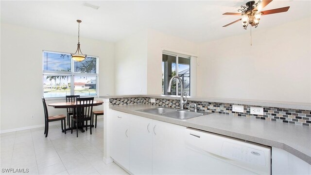 2876 Orange Grove Trl, Naples, FL 34120 - kitchen featuring dishwasher, a sink, backsplash, white cabinets, and a ceiling fan