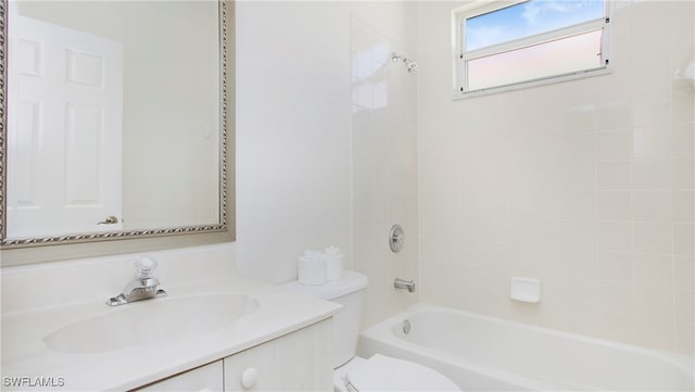 full bathroom with vanity, tiled shower / bath, and toilet