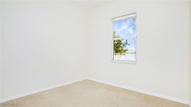 2876 Orange Grove Trl, Naples, FL 34120 - unfurnished room with light colored carpet and baseboards