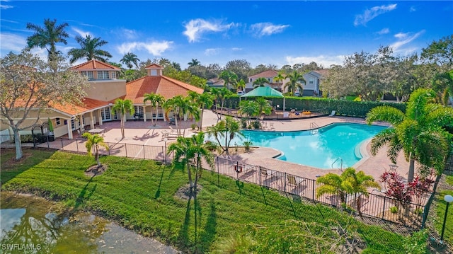 view of swimming pool with a yard and a patio