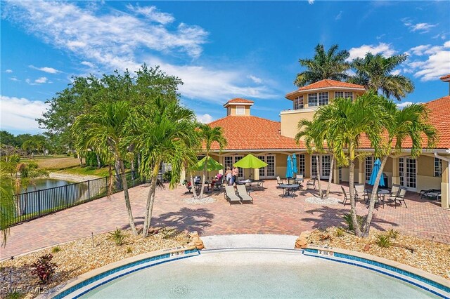 2876 Orange Grove Trl, Naples, FL 34120 - view of swimming pool with french doors, a patio area, and a water view