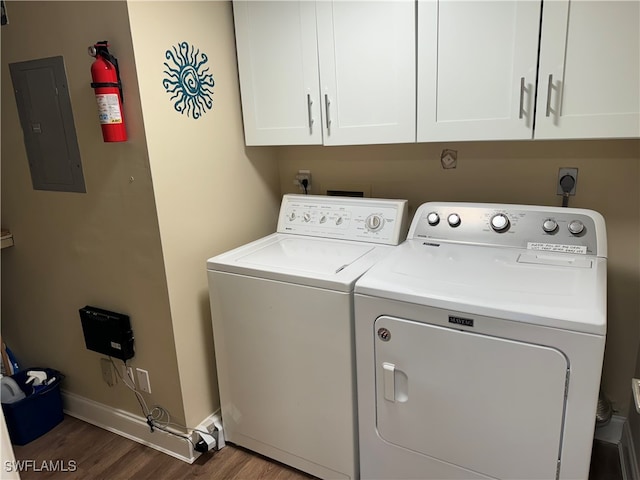 laundry room with electric panel, dark hardwood / wood-style floors, cabinets, and independent washer and dryer