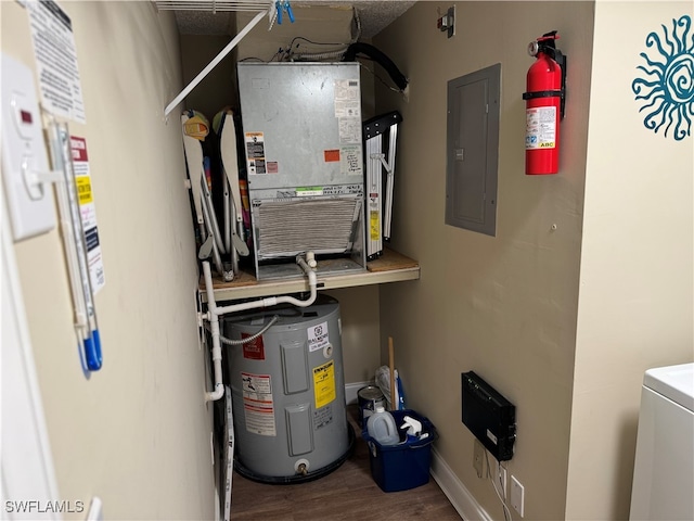 utility room featuring electric panel and water heater