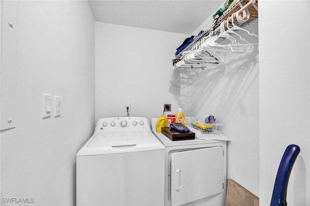 clothes washing area featuring washer and clothes dryer