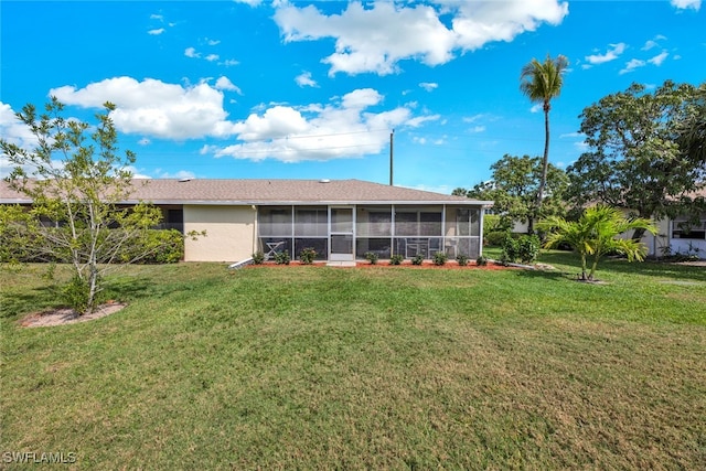 back of house with a lawn and a sunroom