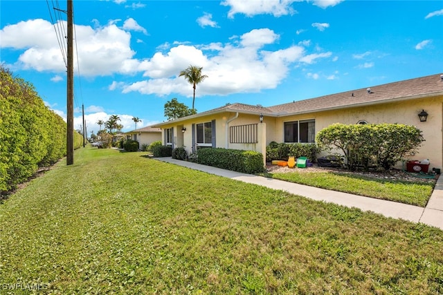 single story home featuring a front lawn