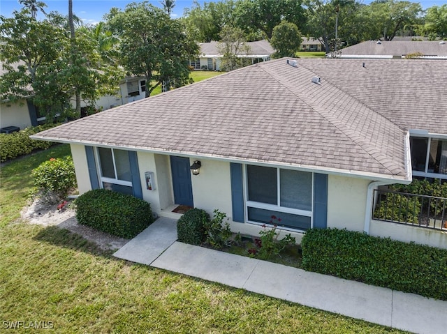 ranch-style home with a front lawn