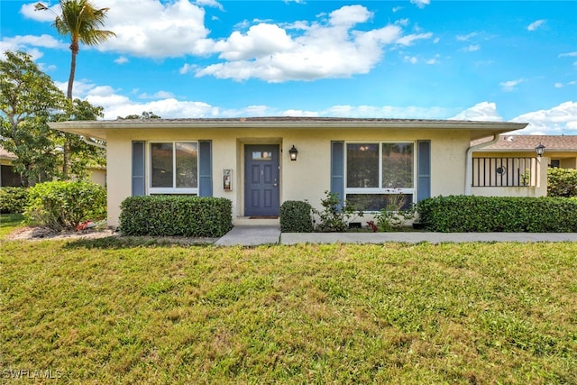 ranch-style home featuring a front yard