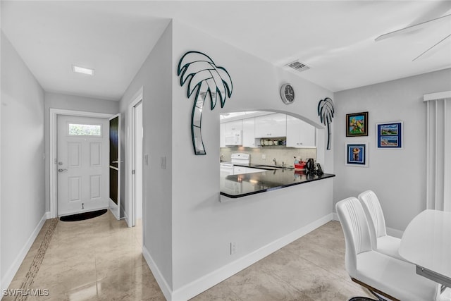 interior space featuring ceiling fan and light tile patterned floors