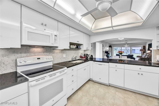 kitchen with white cabinets, white appliances, ceiling fan with notable chandelier, and sink