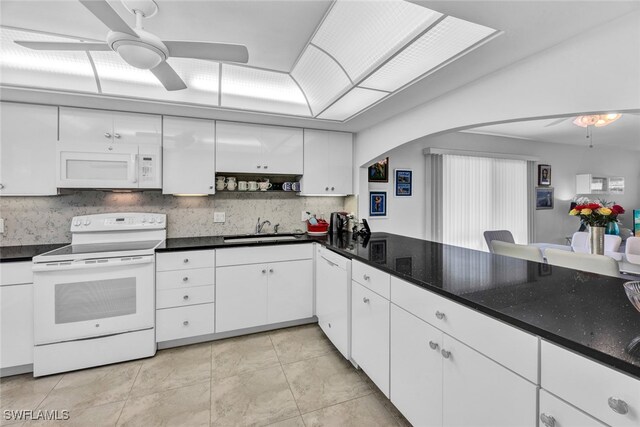 kitchen with sink, ceiling fan, backsplash, white cabinetry, and white appliances