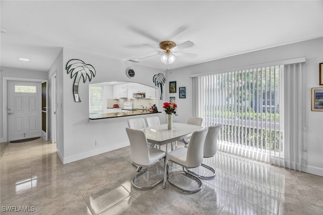 tiled dining area featuring ceiling fan