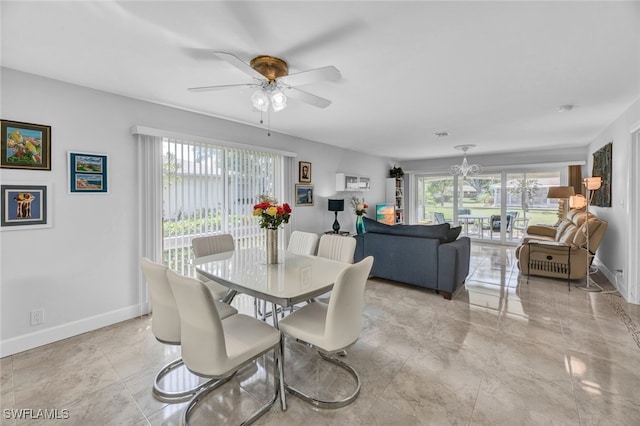 dining space with a wealth of natural light and ceiling fan