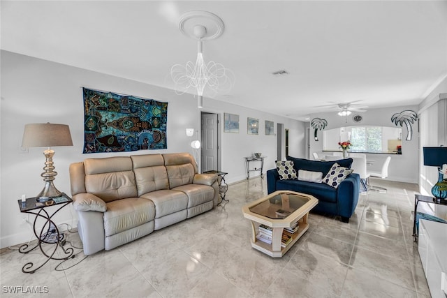 living room with ceiling fan with notable chandelier