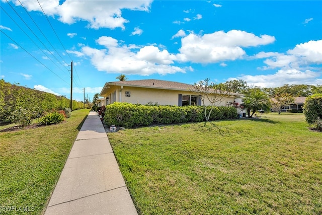 view of side of home with a yard