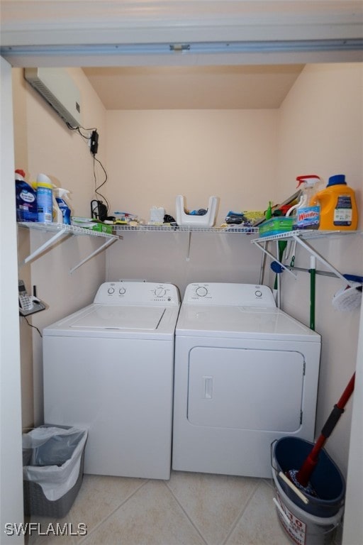 laundry area featuring independent washer and dryer and light tile patterned flooring