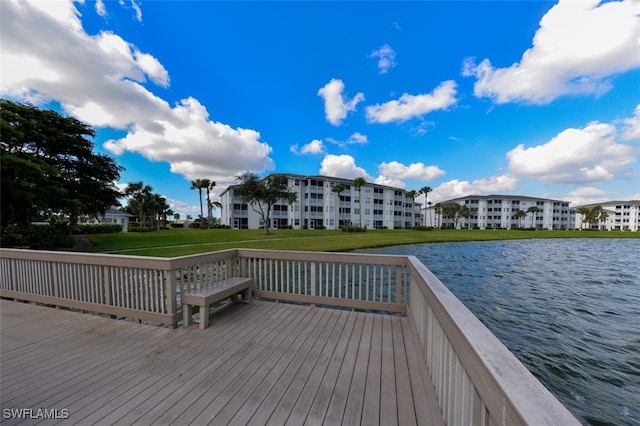 dock area featuring a lawn and a water view