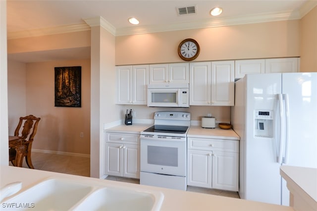 kitchen with white cabinets, light tile patterned flooring, white appliances, and ornamental molding