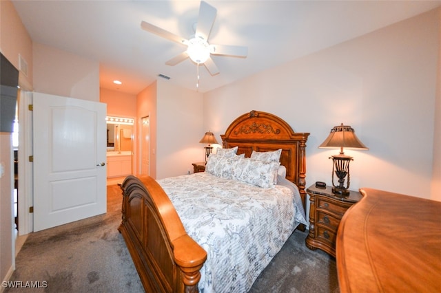 carpeted bedroom with ceiling fan and ensuite bath