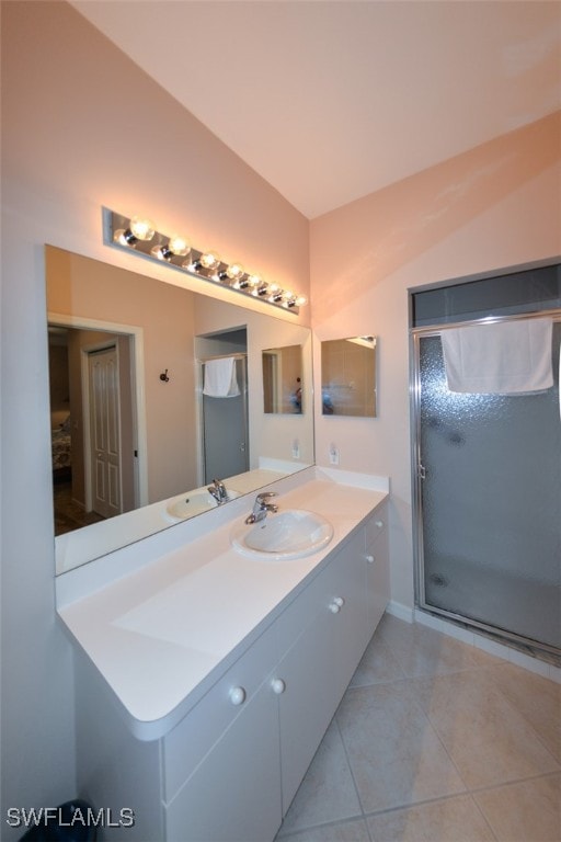 bathroom with tile patterned flooring, vanity, and a shower with shower door