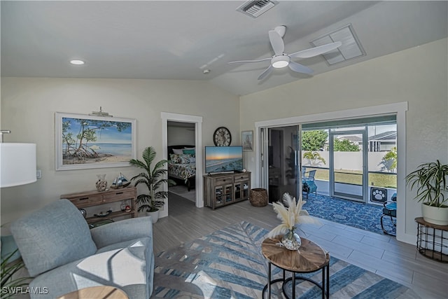 living room featuring ceiling fan and vaulted ceiling