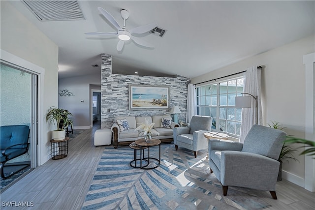 living room with ceiling fan and lofted ceiling