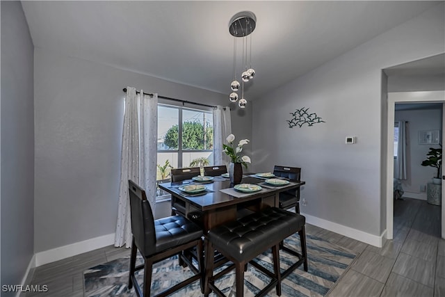 dining space featuring lofted ceiling