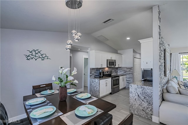 dining room featuring lofted ceiling