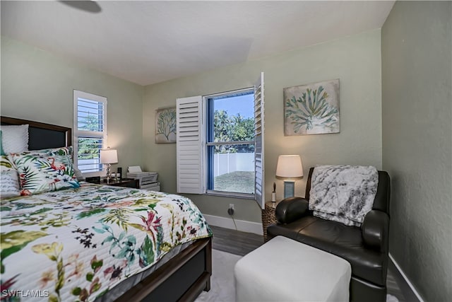 bedroom featuring wood-type flooring and multiple windows