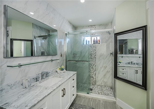 bathroom featuring decorative backsplash, vanity, and walk in shower