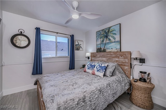 bedroom with hardwood / wood-style floors and ceiling fan