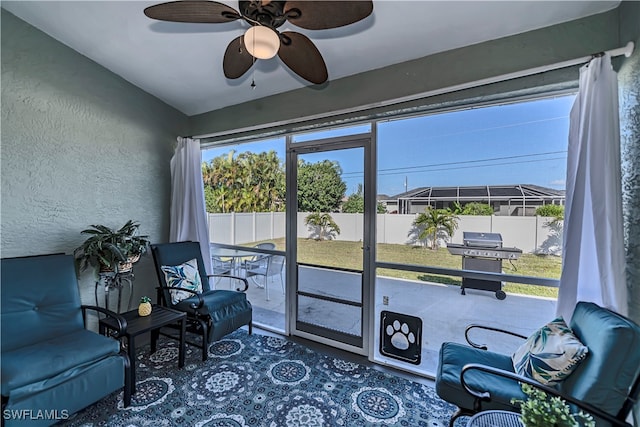 sunroom with vaulted ceiling and ceiling fan