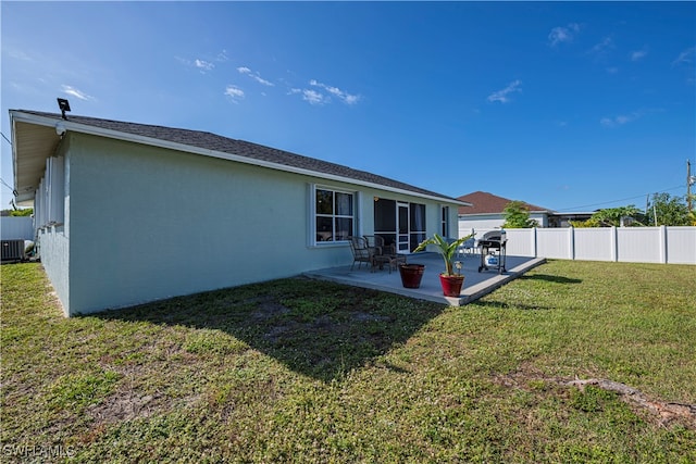 back of property featuring a yard, central AC, and a patio area