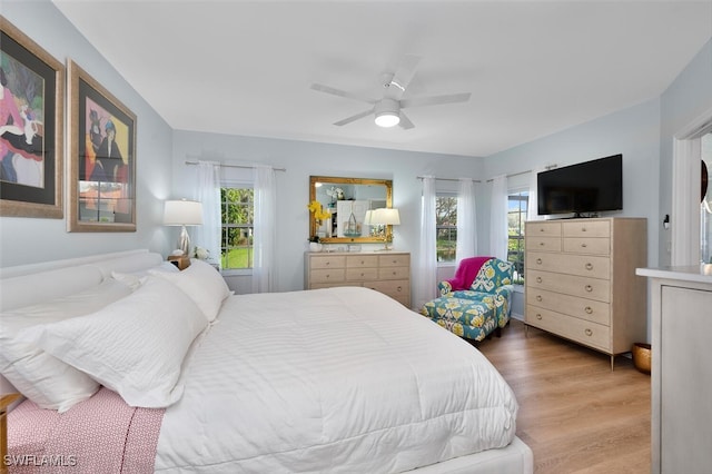 7576 Oleander Gate Dr Unit 101, Naples, FL 34109 - bedroom with multiple windows, wood finished floors, and ceiling fan