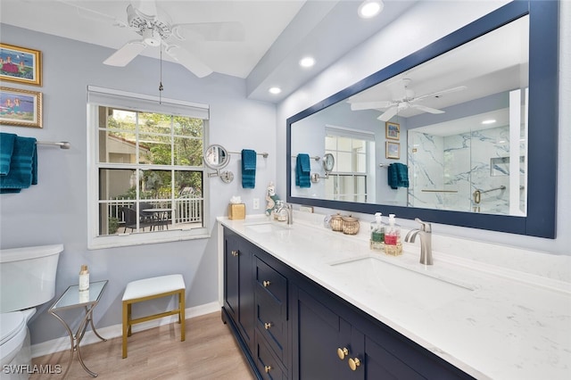 7576 Oleander Gate Dr Unit 101, Naples, FL 34109 - bathroom featuring a ceiling fan, toilet, recessed lighting, double vanity, and a marble finish shower