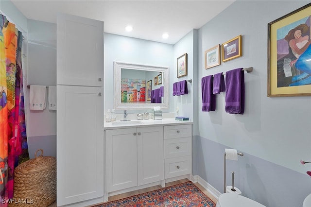 7576 Oleander Gate Dr Unit 101, Naples, FL 34109 - full bath with vanity, toilet, baseboards, recessed lighting, and wood finished floors