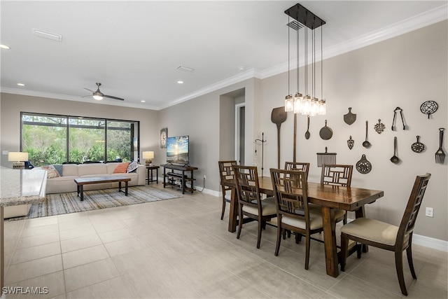 tiled dining space with ceiling fan and ornamental molding