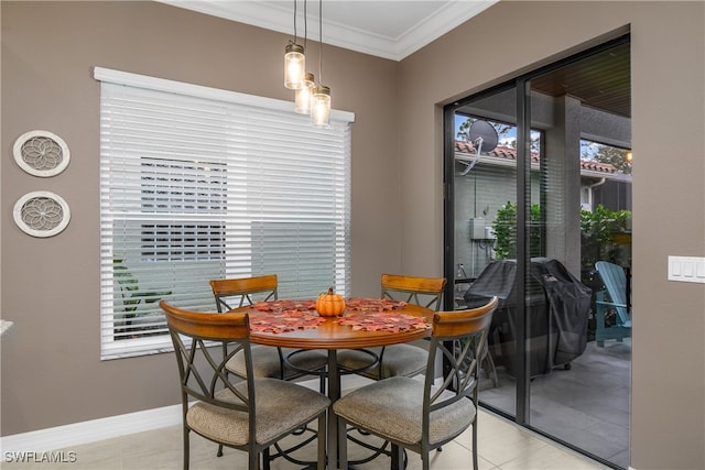 tiled dining space with ornamental molding and a healthy amount of sunlight